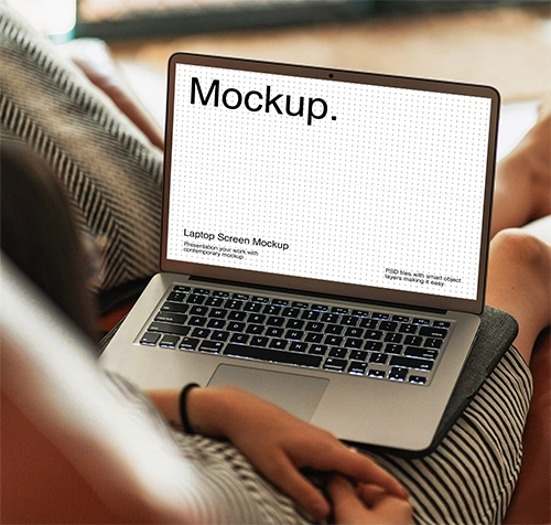Women on sofa using laptop with screen mockup